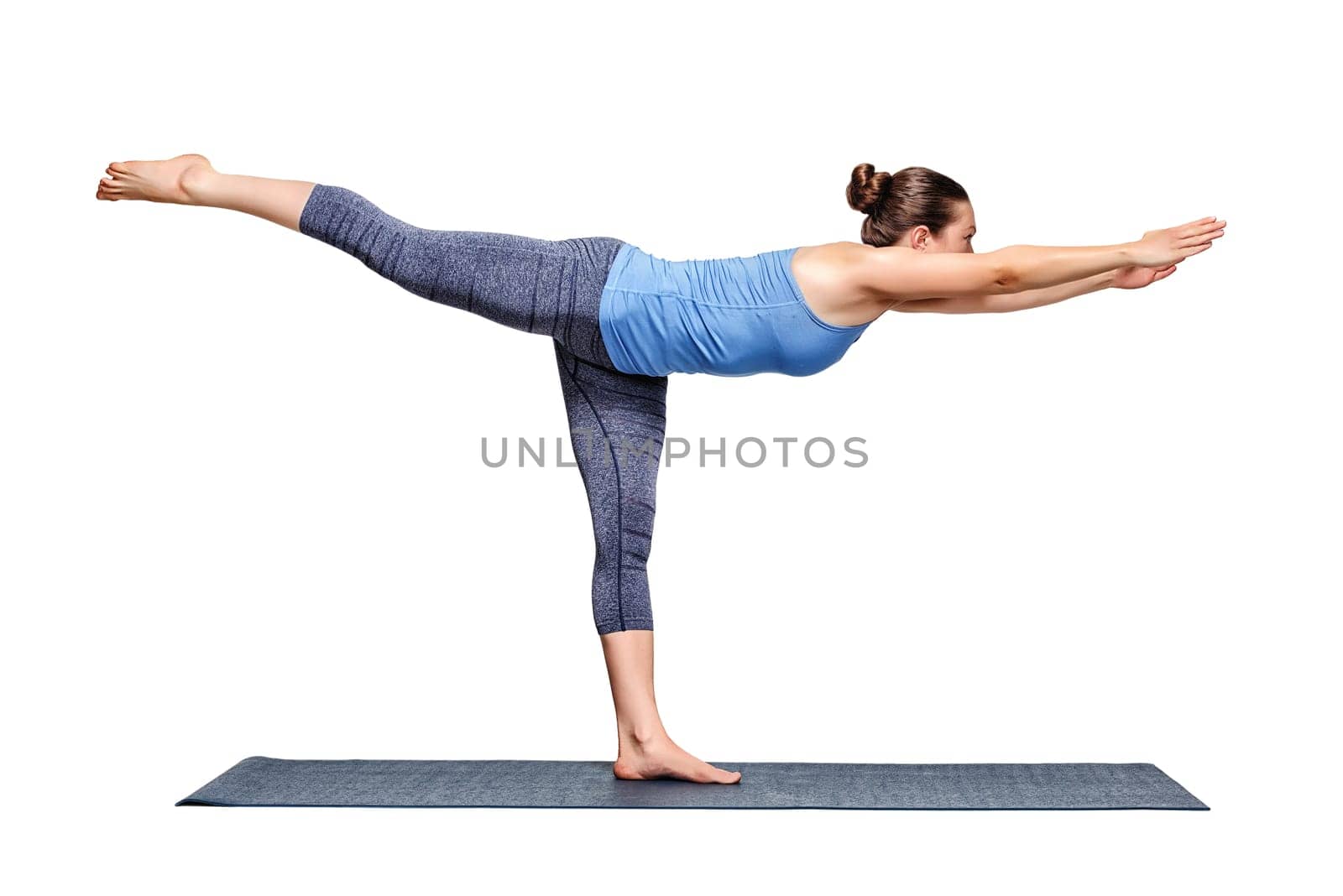 Beautiful sporty fit woman practices yoga asana Virabhadrasana 3 - warrior 3 pose isolated on white