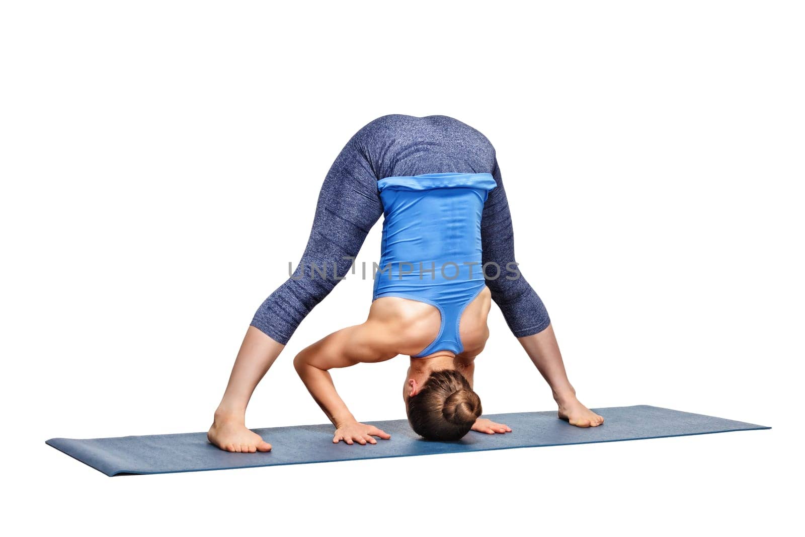 Sporty fit woman practices Ashtanga Vinyasa yoga asana Prasarita by dimol