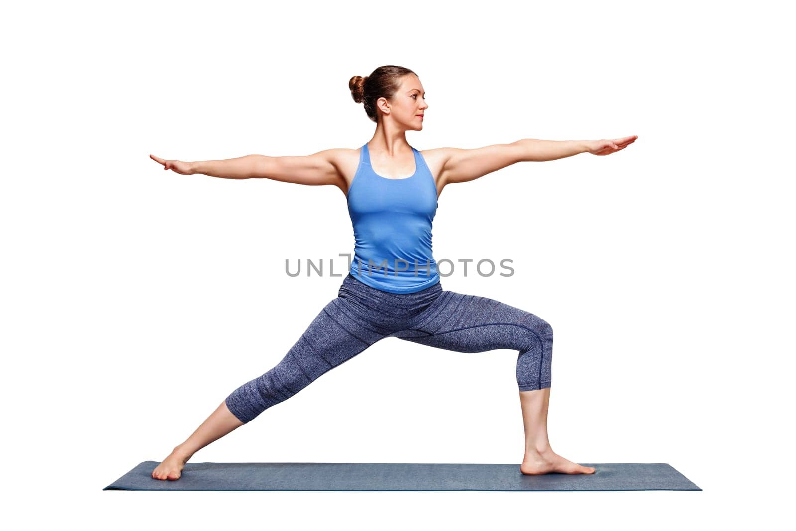 Sporty fit woman practices yoga asana utthita Virabhadras by dimol