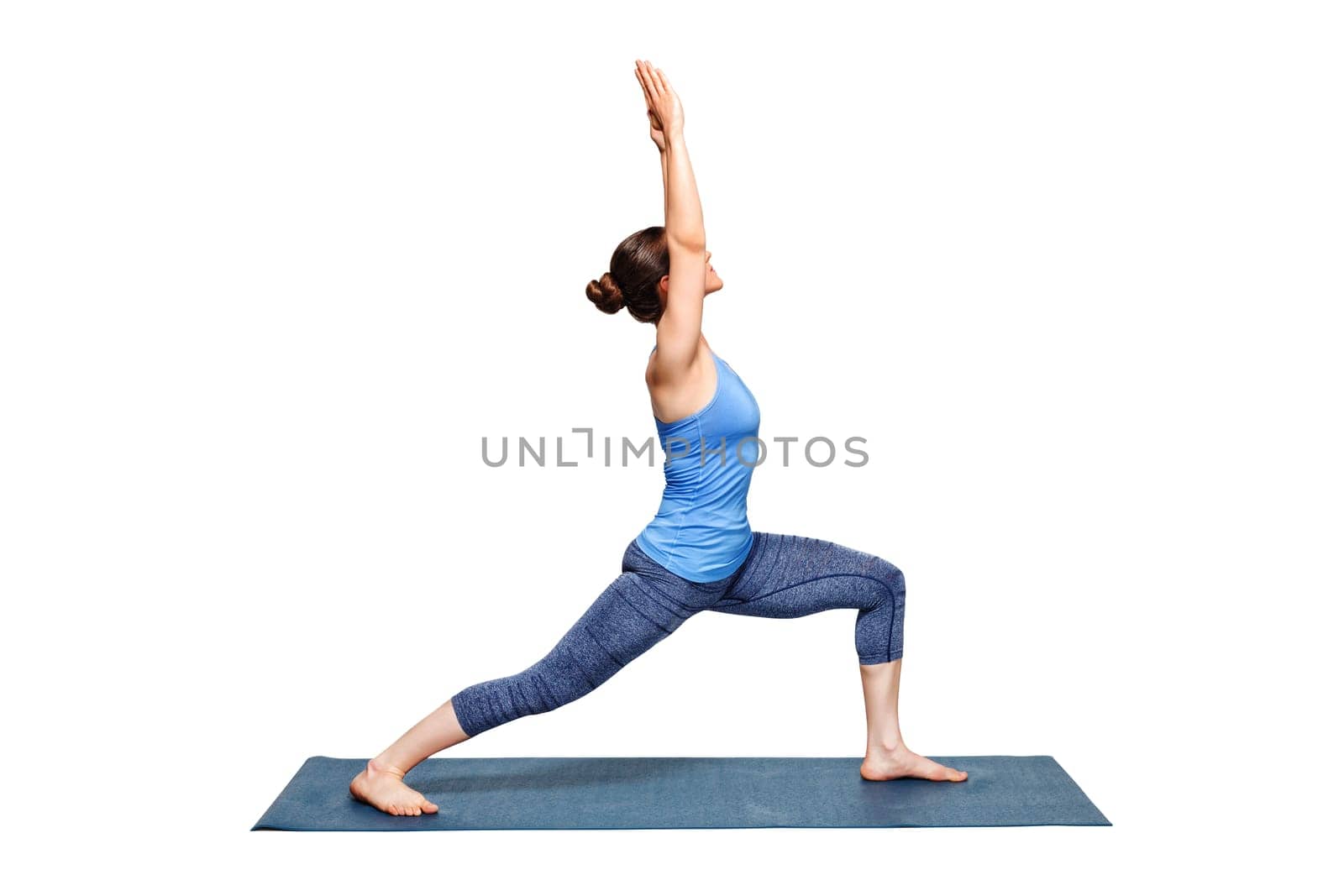 Beautiful sporty fit woman practices Ashtanga Vinyasa Yoga asana Virabhadrasana 1 - warrior pose 1 isolated on white