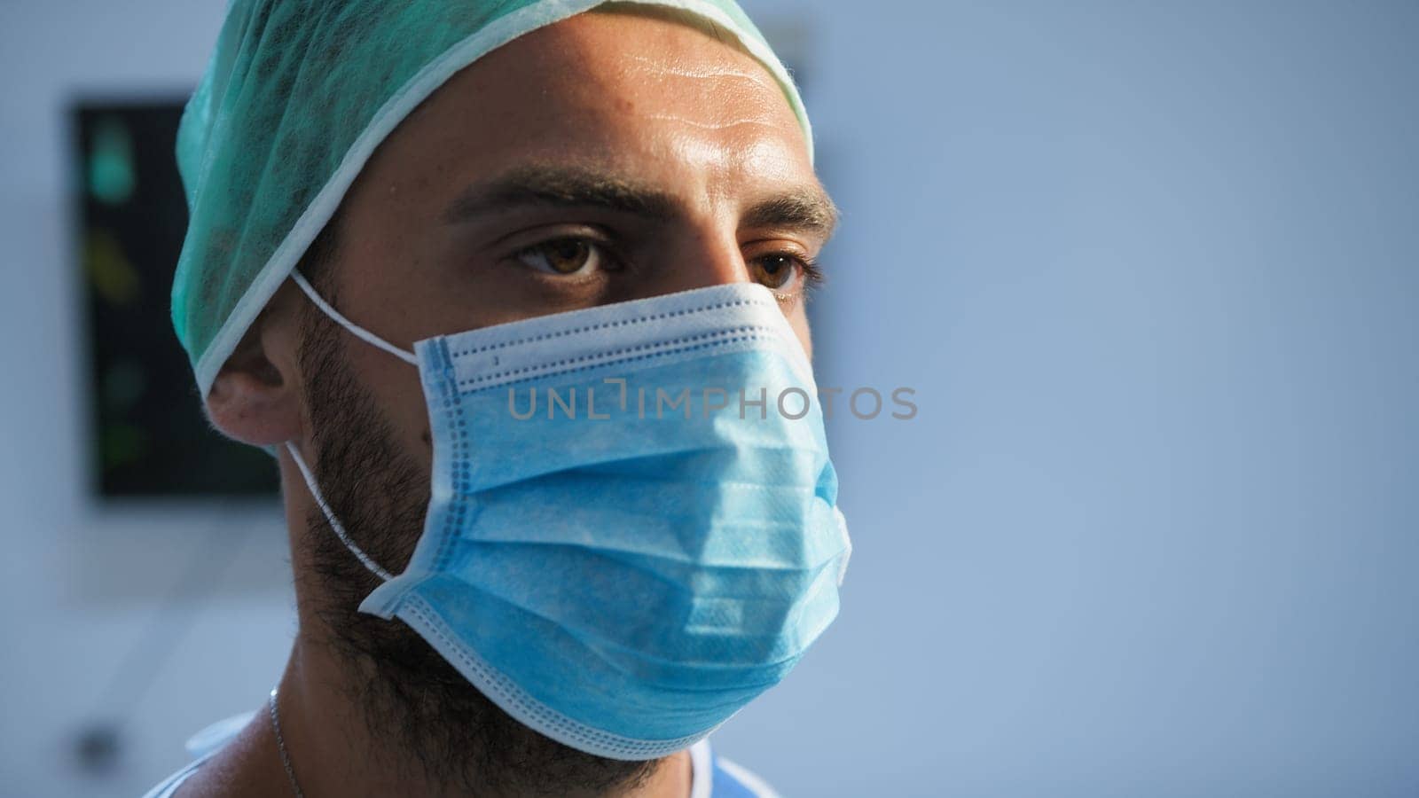 Italian Dentist wears mask before surgery.