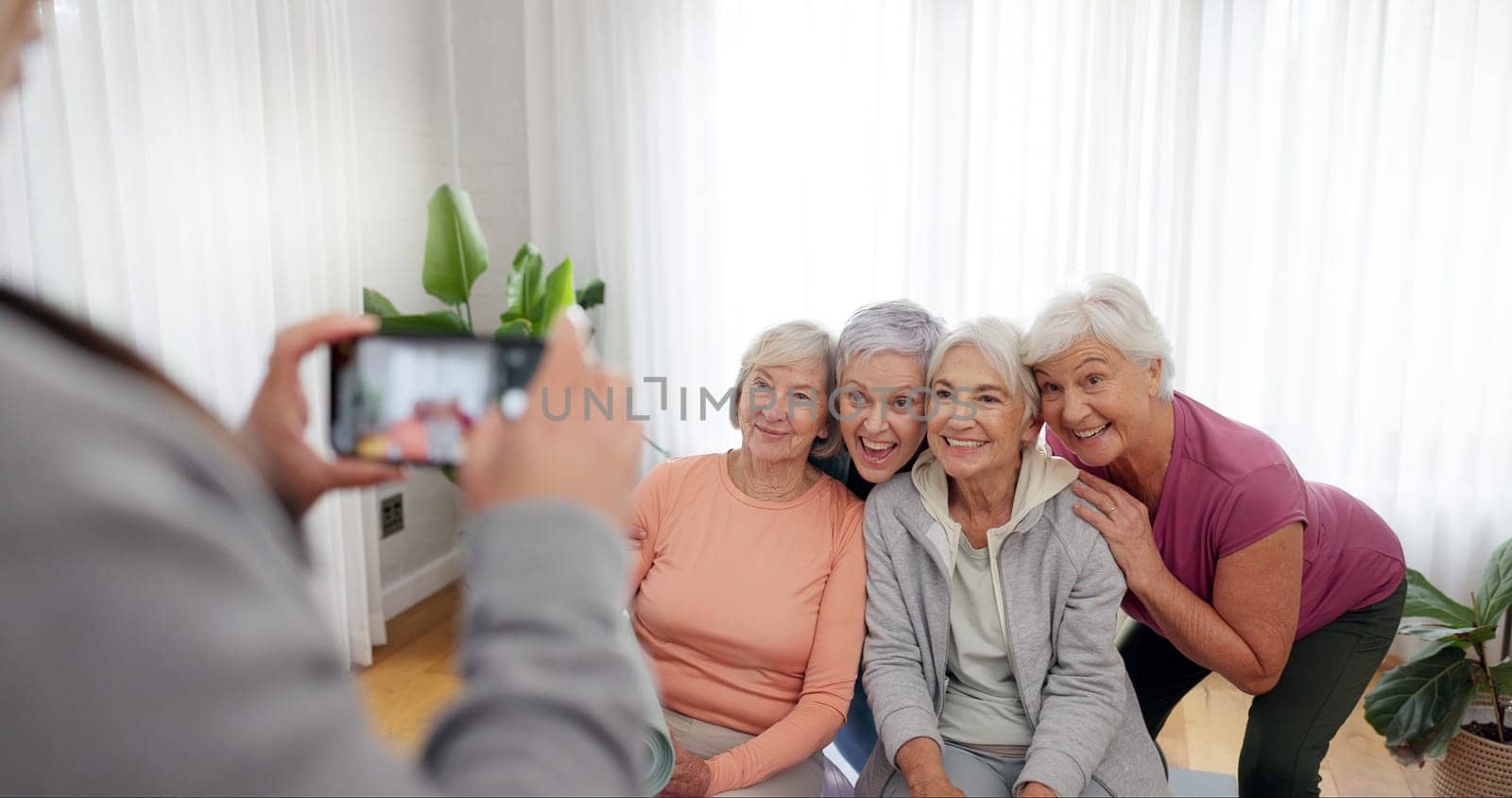Senior fitness, women and person with a photo for a yoga, exercise or workout memory together. Smile, group and coach taking picture of elderly friends at a training studio for a class in retirement.