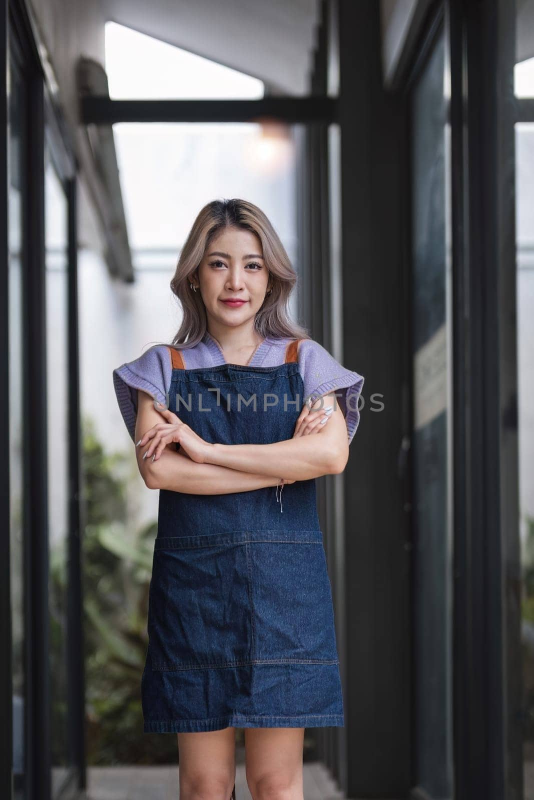 Opening a small business, A Happy Asian woman in an apron standing near a bar counter coffee shop, Small business owner, restaurant, barista, cafe, Online, SME, entrepreneur, and seller concept.