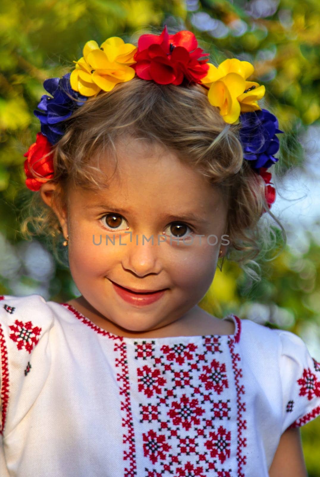 Child Ukrainian in a wreath. Selective focus. Nature.