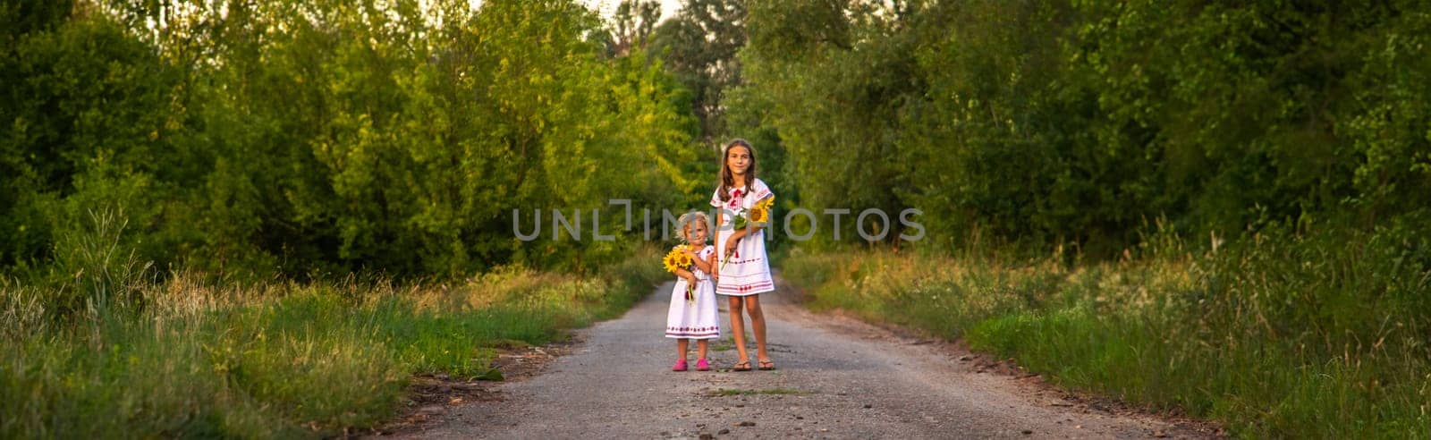 A child in a field of sunflowers Ukraine. Selective focus. by yanadjana