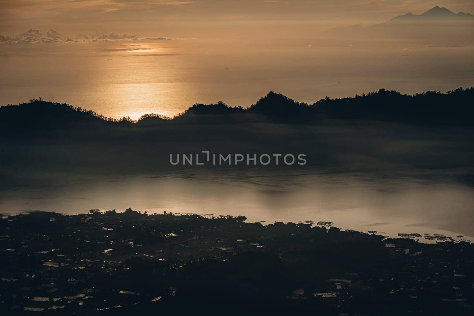 Early morning sunrise clouds at mountain Batur. Dawn mist covering volcano Batur