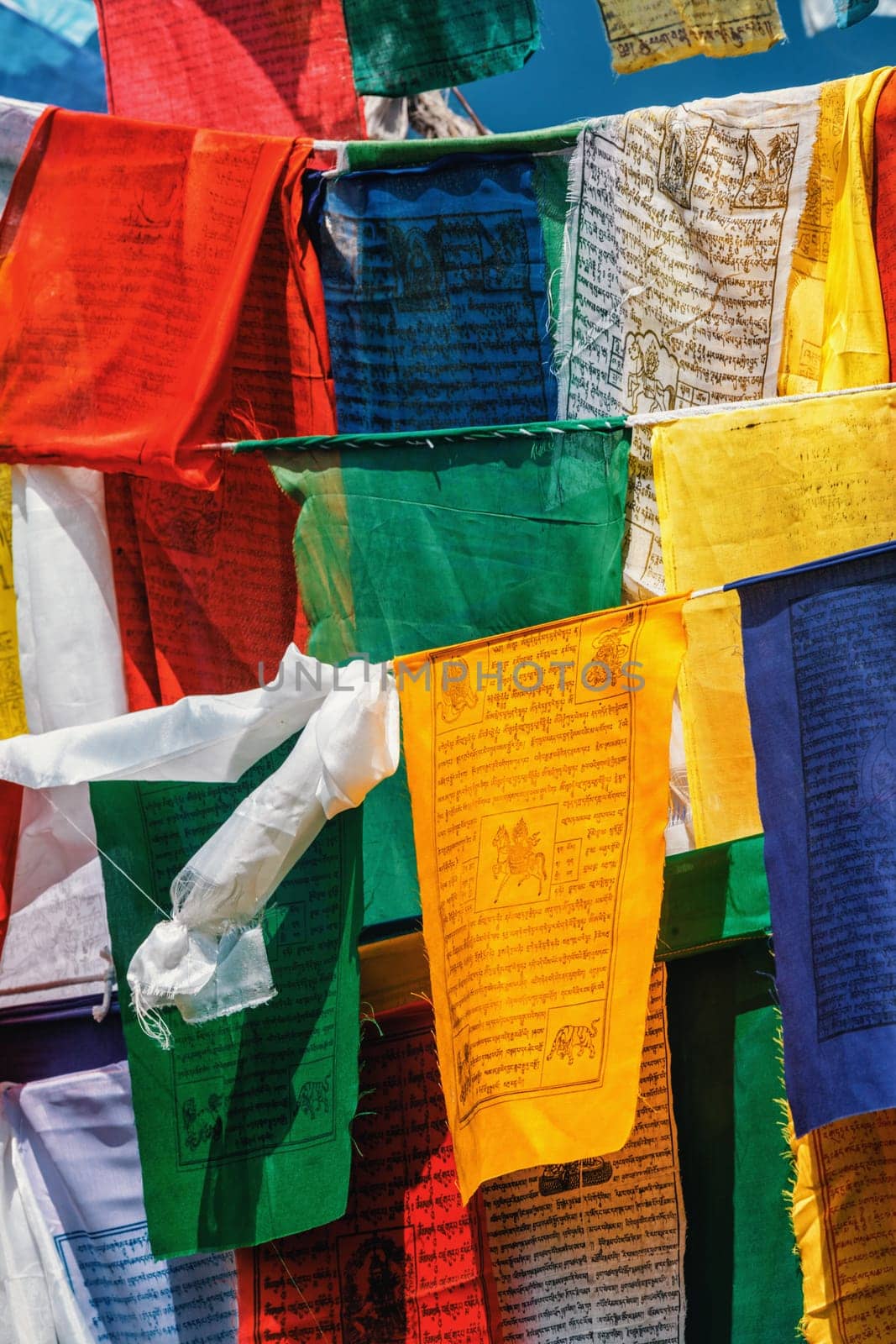 Buddhist prayer flags lungta with Om Mani Padme Hum Buddhist mantra prayer meaning Praise to the Jewel in the Lotus on kora around Tsuglagkhang complex. McLeod Ganj, Himachal Pradesh, India