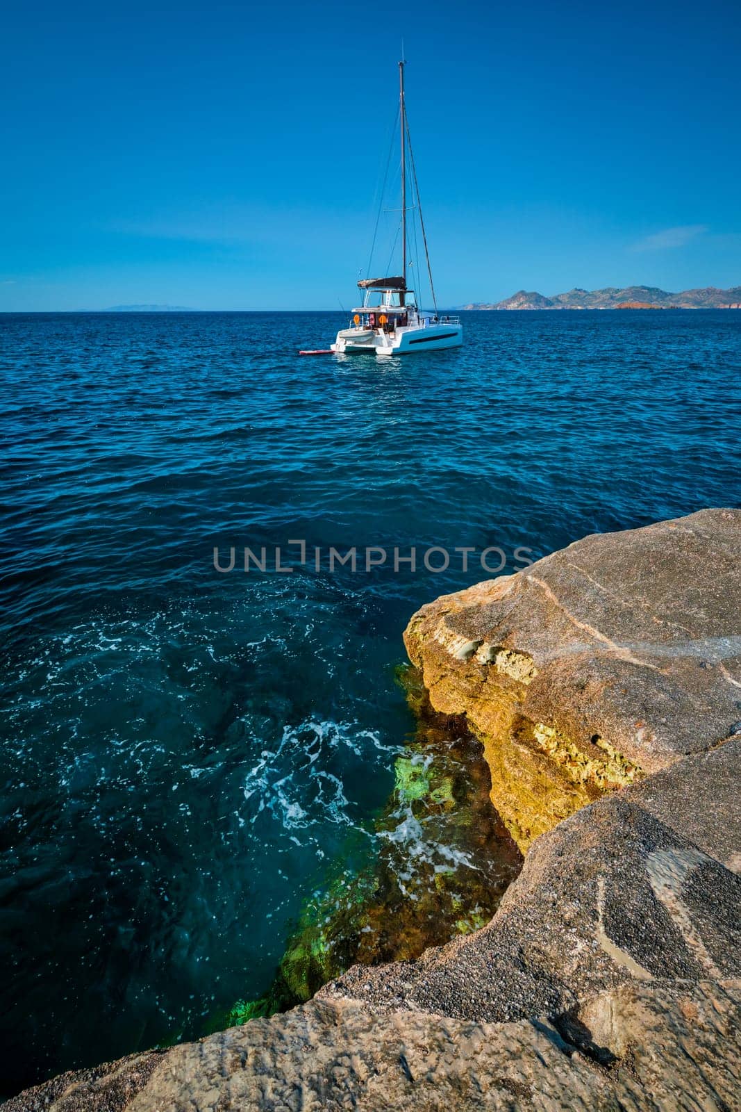 Yacht boat in Aegean sea at white rocks of Sarakiniko Beach, Milos island , Greece