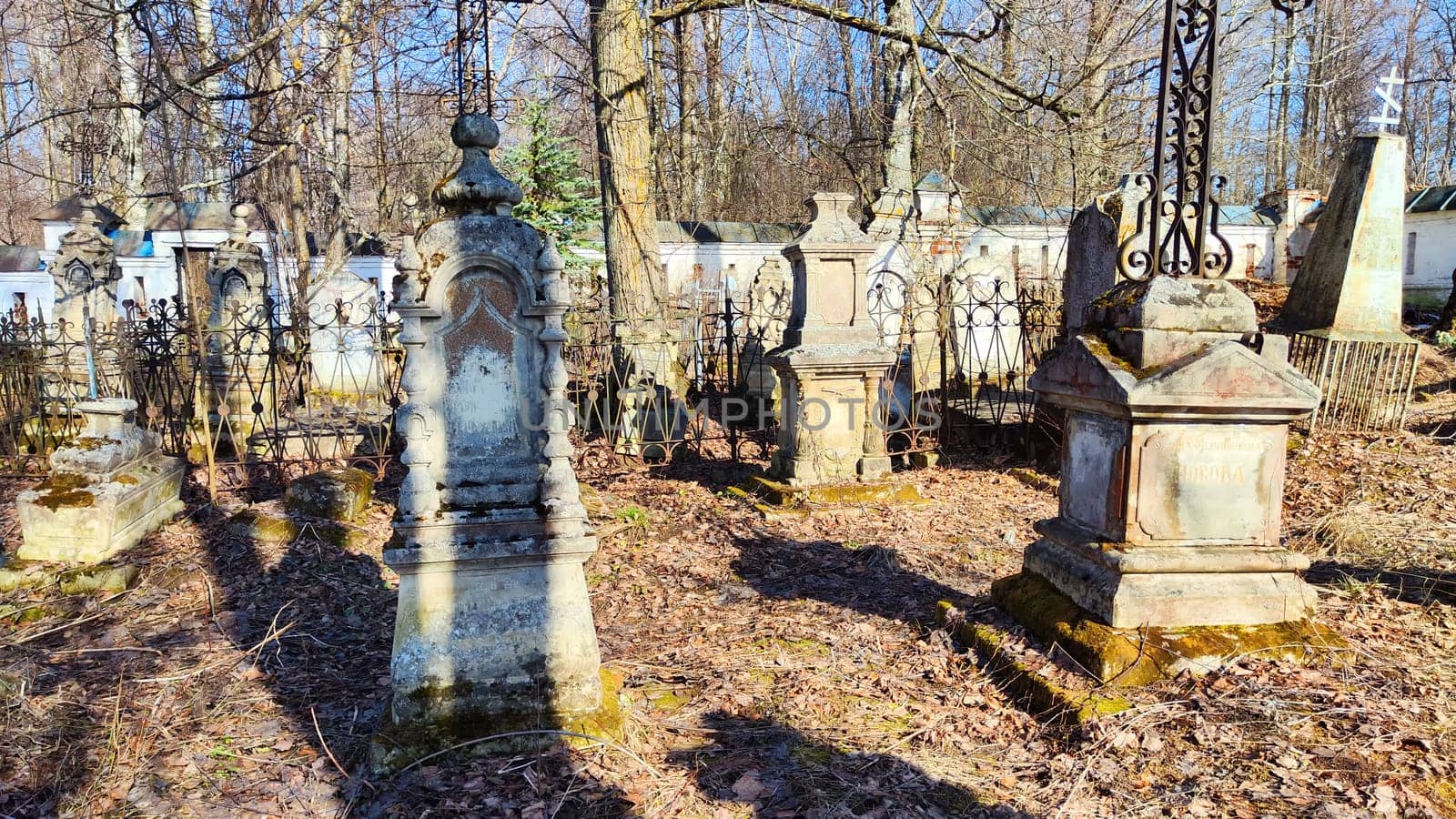 Sovetsk, Russia - April 03, 2023: Cemetery with old tombstones on sunny day in spring. Image with selective focus