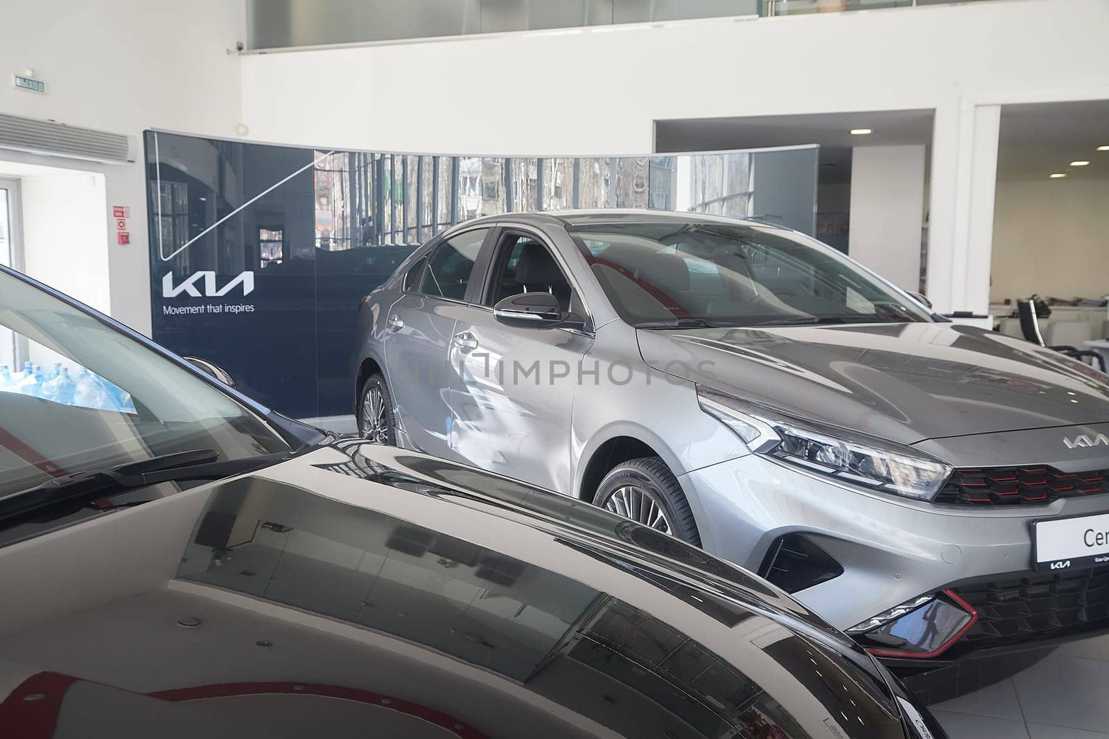 Kirov, Russia - April 12, 2022: Cars in showroom of dealership Kia in Kazan in Russia. Partial focus