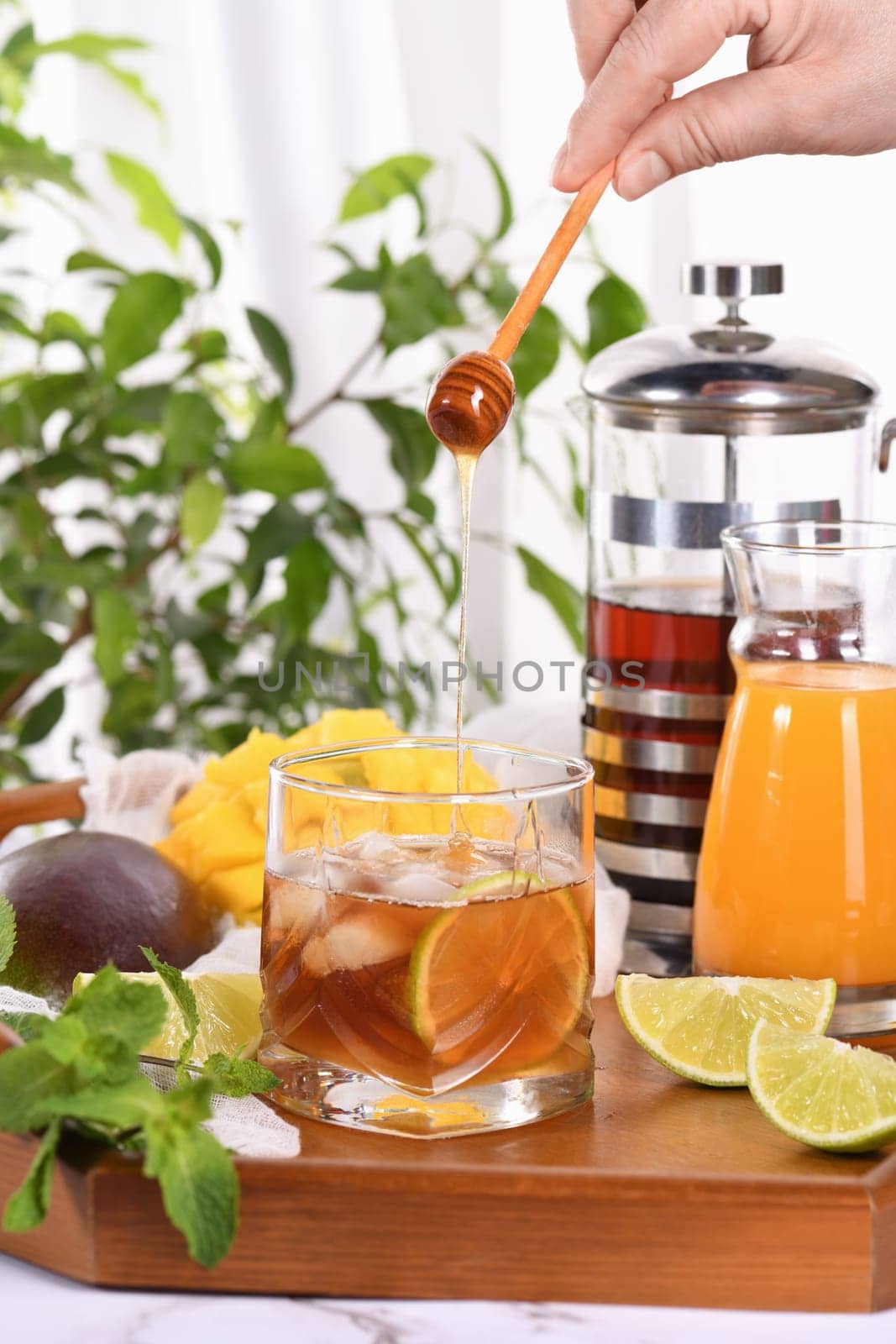 Mango iced tea with lime and mint has the perfect ratio of juice, tea and mint, sweetened with honey and so fresh and delicious. by Apolonia