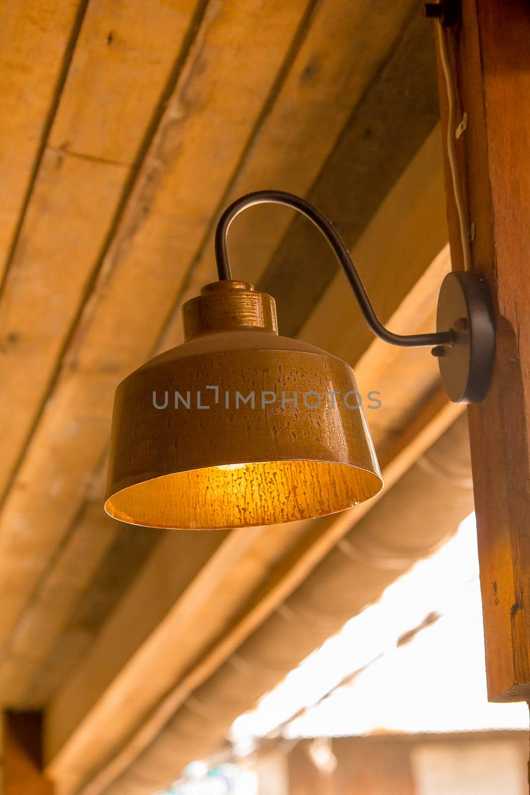 Old brass lamp with wooden pole