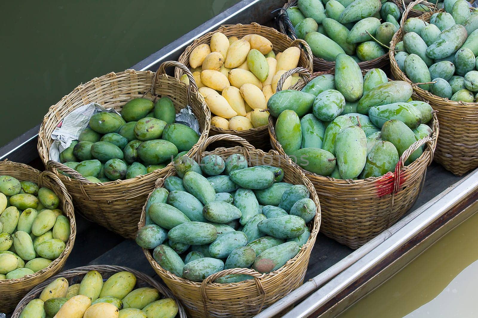 The mango is in the basket on the boat.