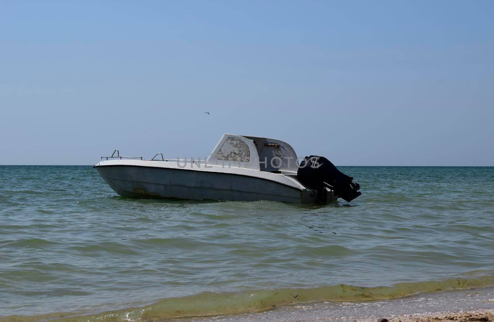 Motor boat on the background of the sea near the coast.