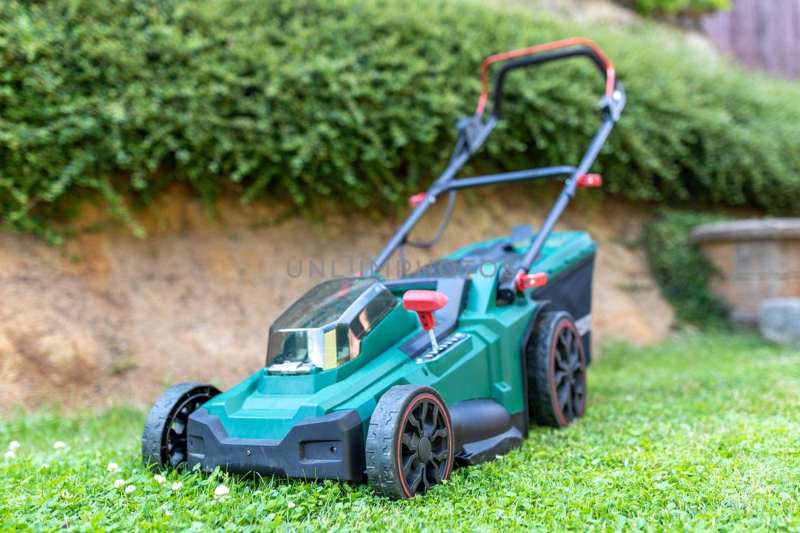 battery electric lawn mowers in the garden by artush