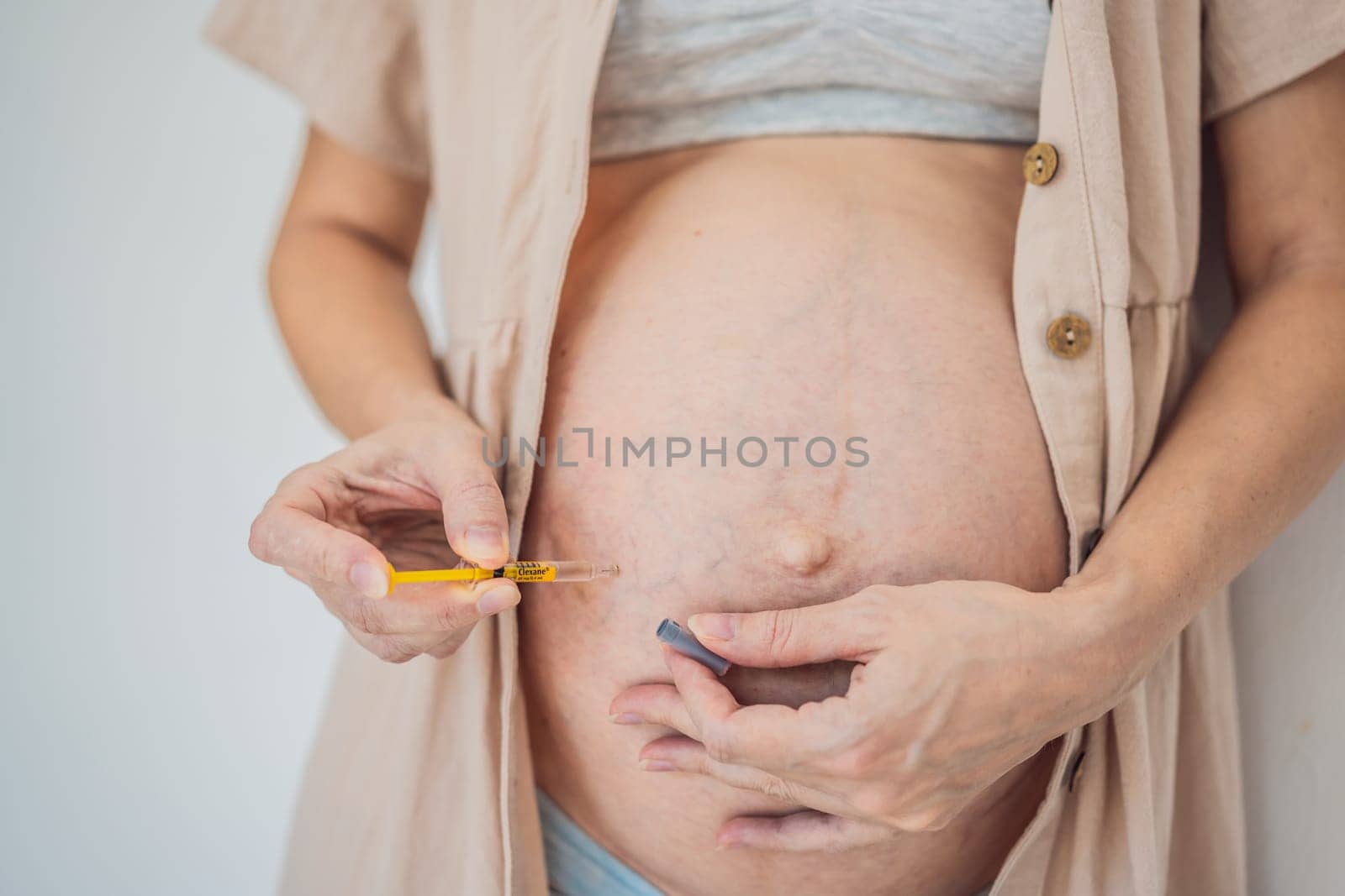 Mexico, Playa del Carmen 3.08.2023: Woman injects a dose of heparin Clexane into her belly