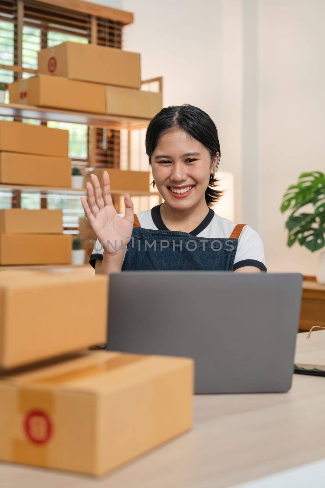Asian female fashion owner social media influencer Live selling product, SME retail store owner smile enjoy selling show live sale online screen laptop work at home.