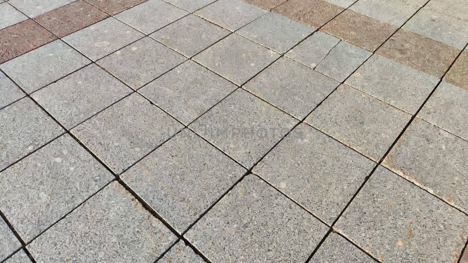 Rows and lines of square sidewalk gray tiles on floor outside or indoors. Street path. Abstract background, texture, pattern, frame, space for text and copy space