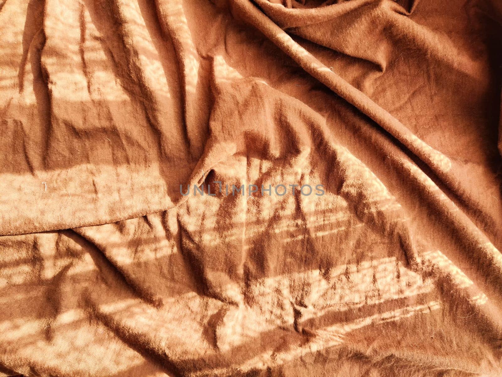 Abstract background and texture of crumpled brown fabric. Texture, pattern, frame and copy space