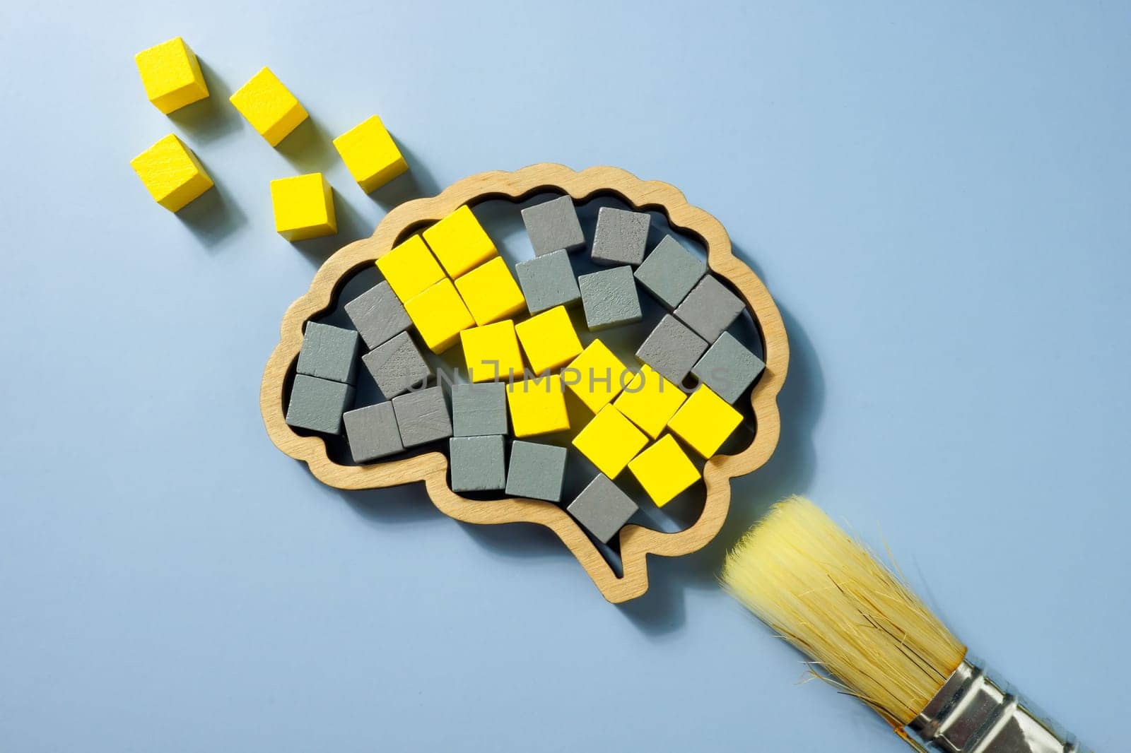A Brush, brain shape with yellow and gray cubes. Cognitive Behavioral Therapy CBT concept. by designer491