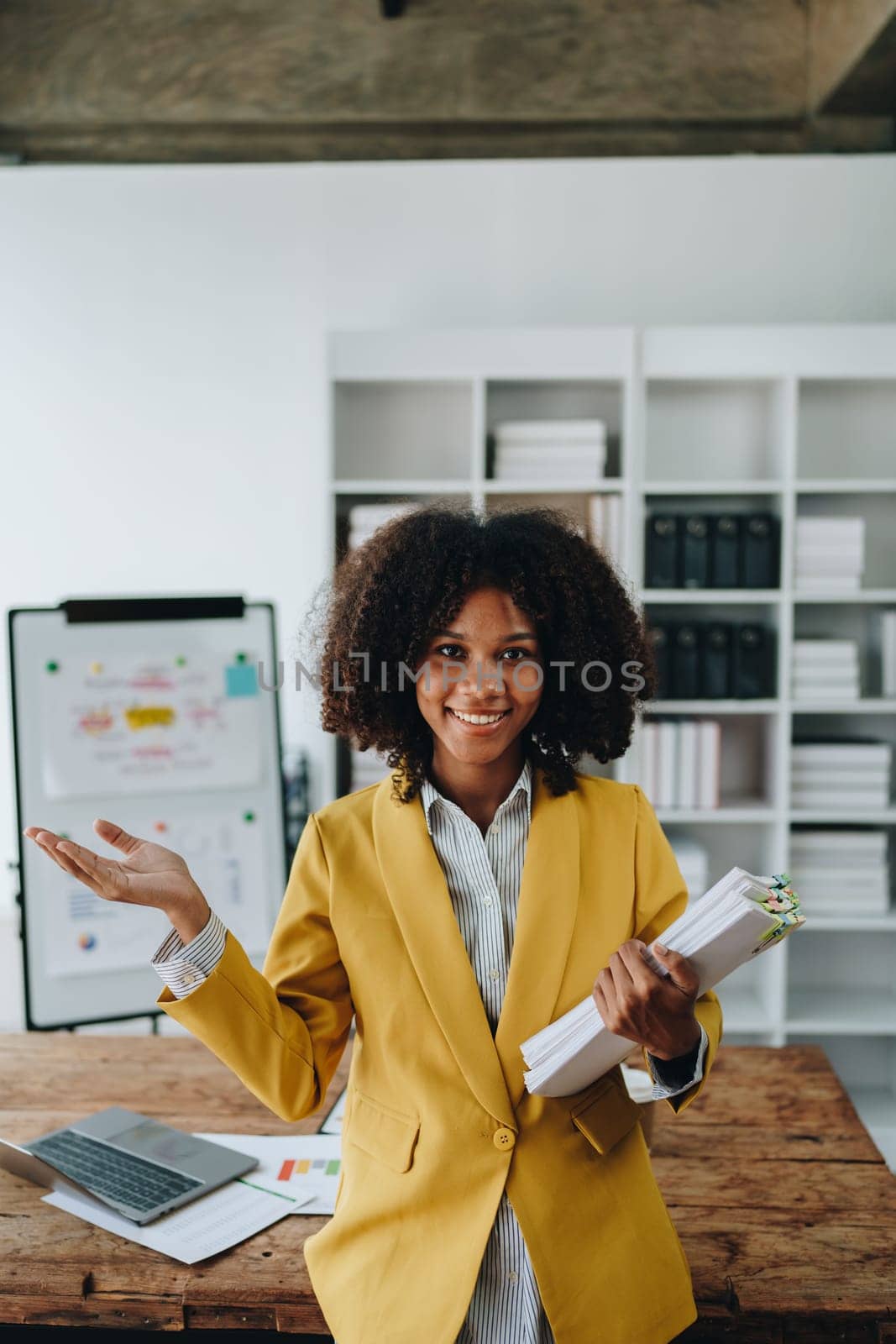 American African business woman using document, computer laptop, calculator, paperwork, documents, in winner and smiling Happy to be successful achievement success. finance and investment concepts by Manastrong