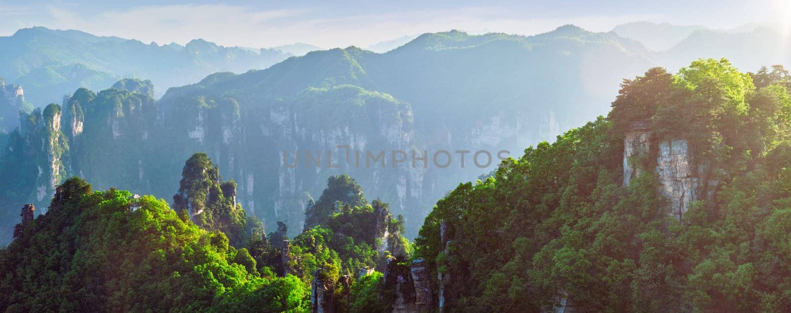 Famous tourist attraction of China - panorama of Zhangjiajie stone pillars cliff mountains on sunset at Wulingyuan, Hunan, China