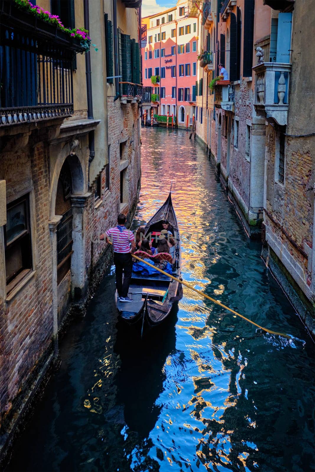Narrow canal with gondola in Venice, Italy by dimol