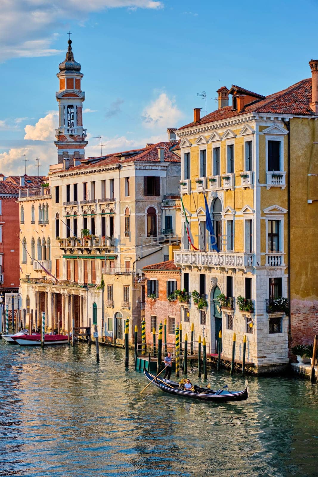 VENICE, ITALY - JUNE 27, 2018: Grand Canal with boats and gondolas on sunset, Venice, Italy