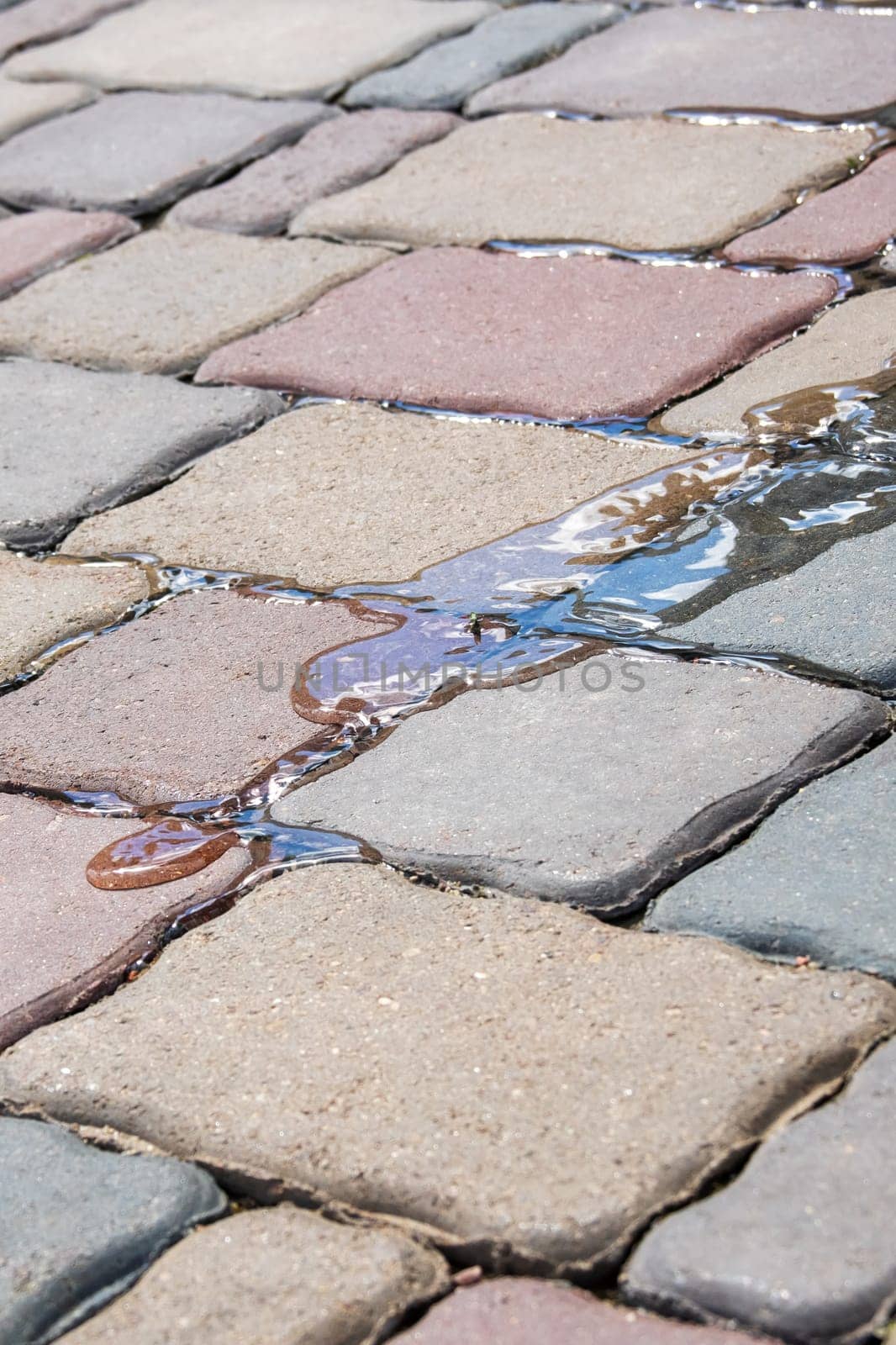 Water flows on paving slabs close up, background