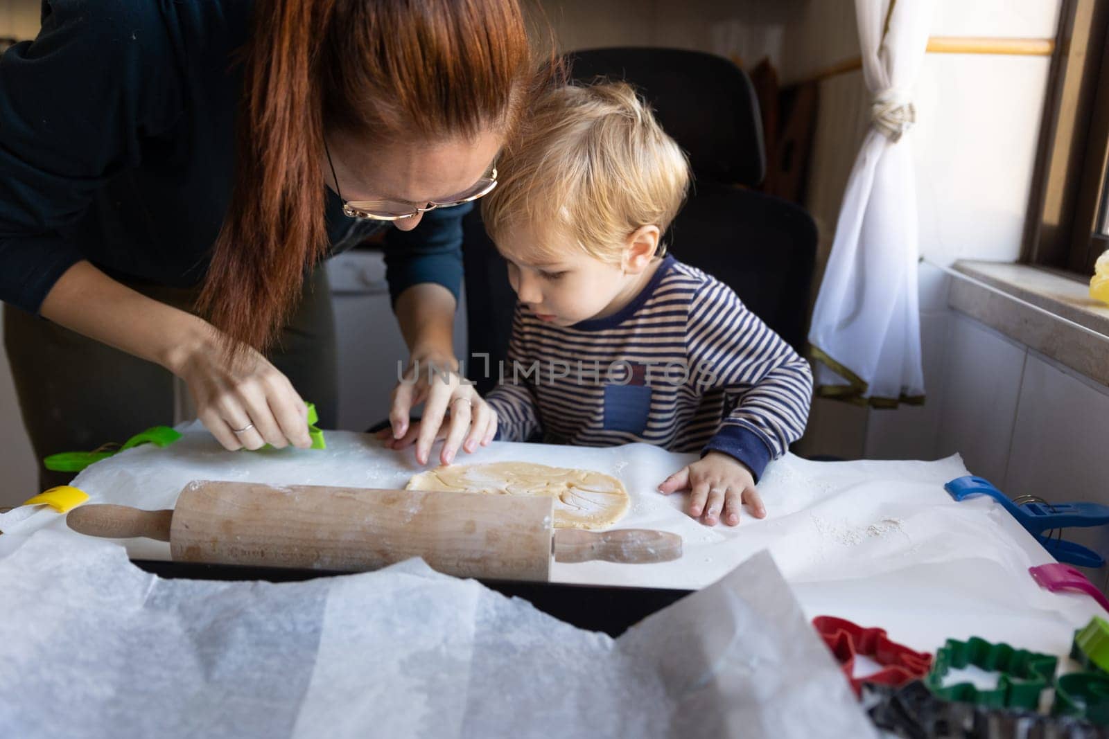 Family cooking - a woman with her little son making cookies. Mid shot