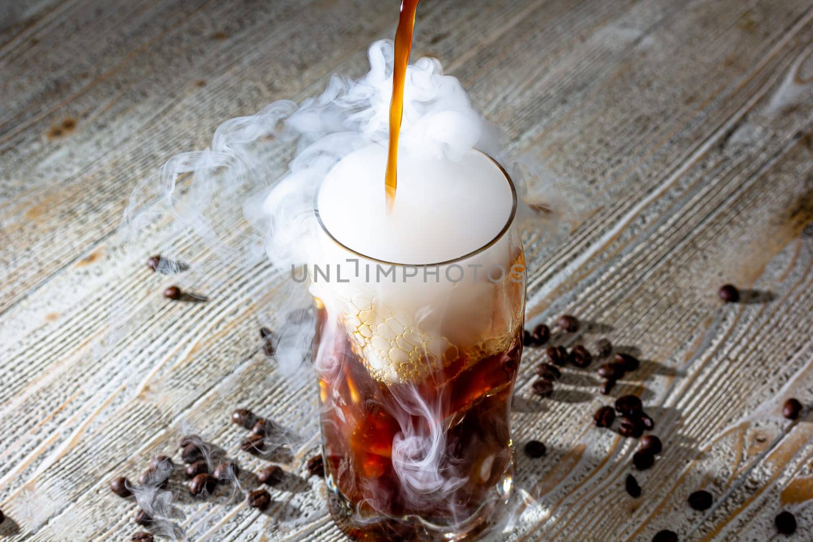 Whisky Smoke. Smoking whiskey with ice and orange on a dark background. Cognac with smoking branch of lavender. by Milanchikov