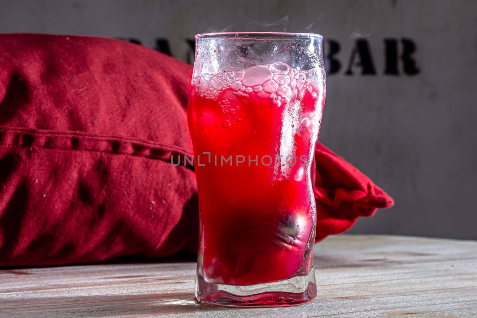 Pink gin cocktail with red blood orange and ice. An alcoholic, refreshing drink by Milanchikov