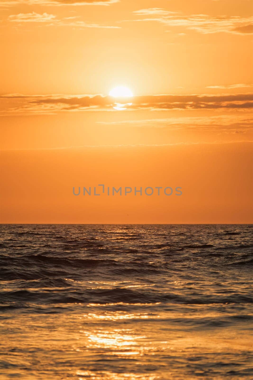 Ocean waves on sunset background by dimol
