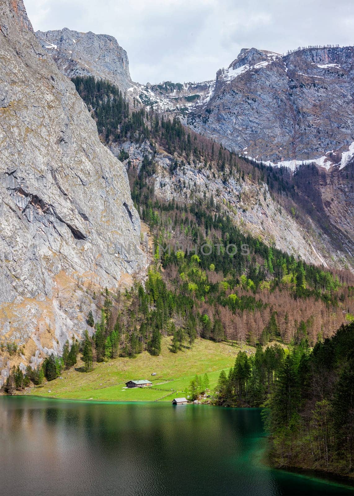 Farm house on mountain lake Obersee lake in Alps mountains. Bavaria, Germany