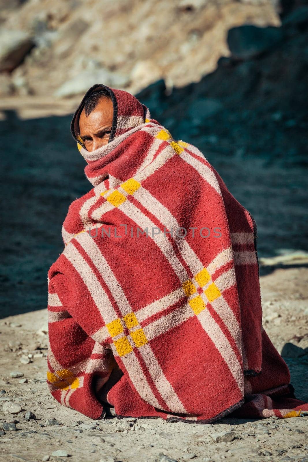 SARCHU, INDIA - SEPTEMBER 2, 2011: Indian man muffled in blanket on cold morning on Manali-Leh road in Himalayas in Ladakh, India