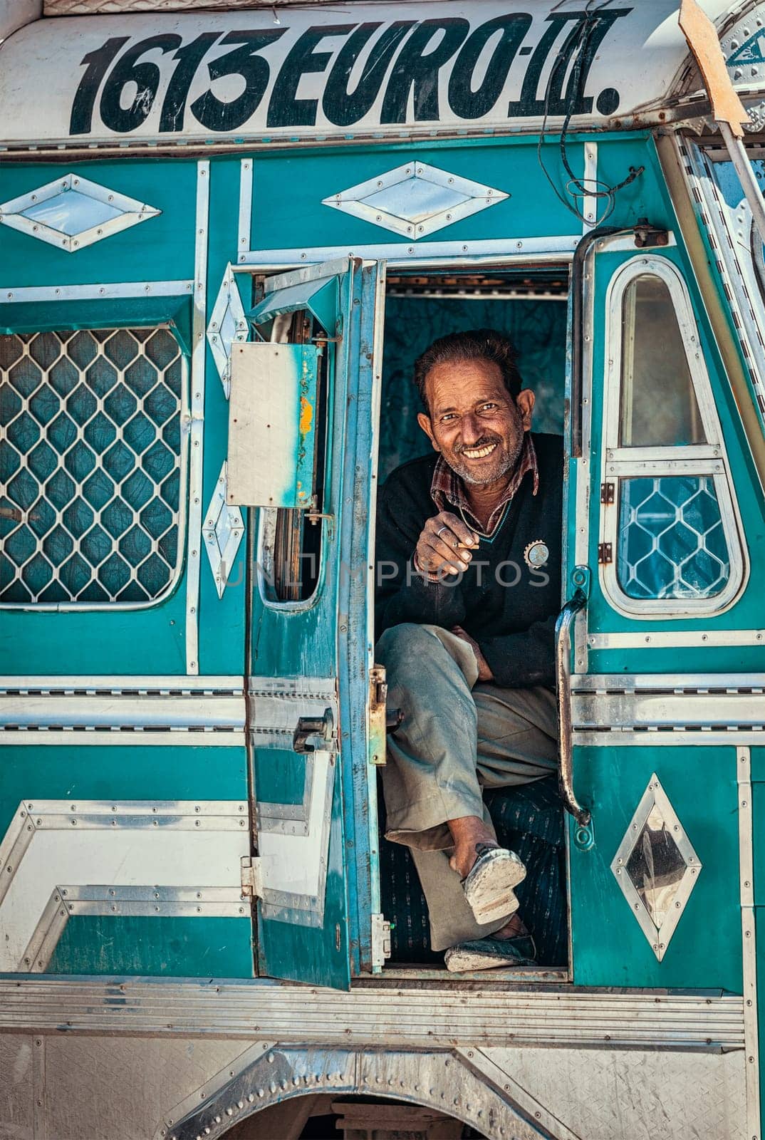 SARCHU, INDIA - SEPTEMBER 2, 2011: Driver in Indian lorry truck on on Manali-Leh road in Himalayas in Ladakh, India