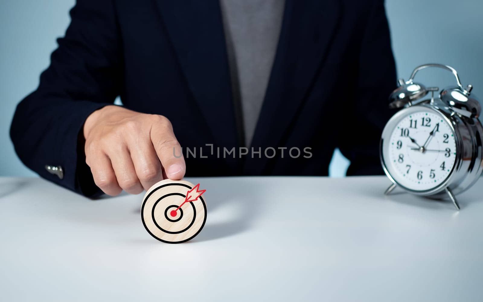 Businessman pointing to the target. Business concept. management concept business planning concept by Unimages2527