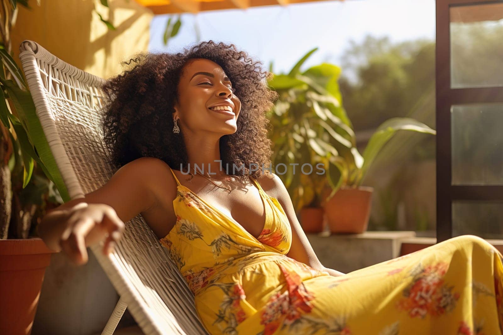 Beautiful African-American woman relaxing on a sun lounger in a gazebo. High quality photo