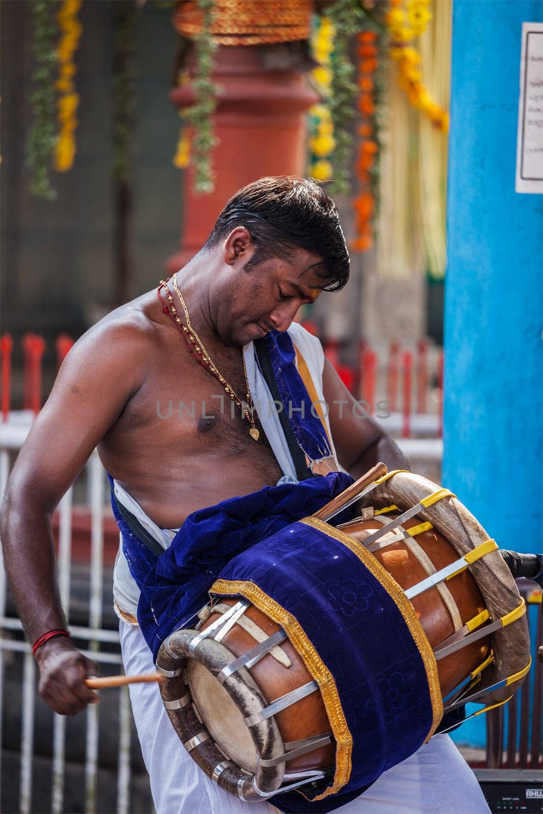 Indian man playing drum during temple festival in Kerala by dimol