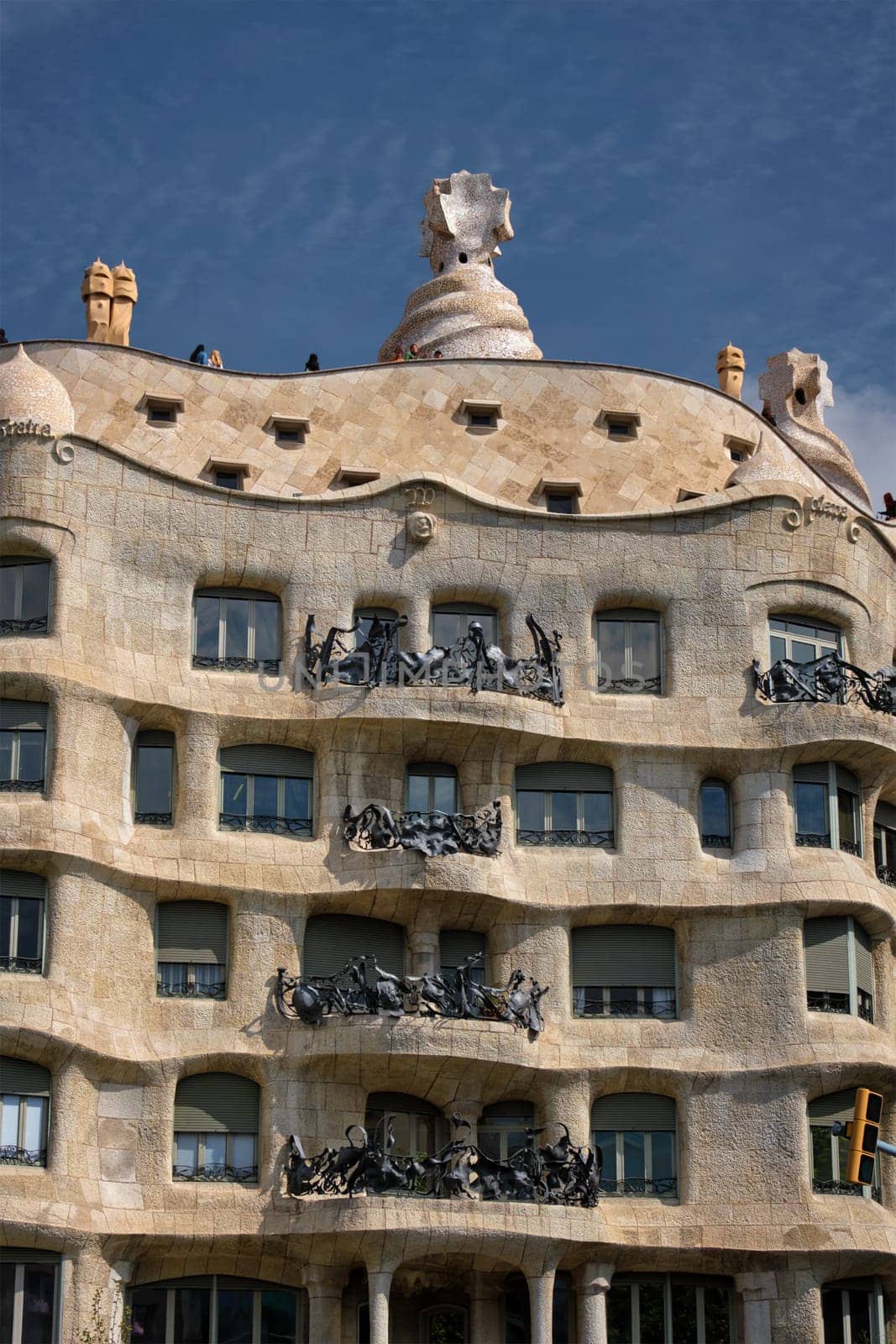 BARCELONA, SPAIN - APRIL 15, 2019: Famous Casa Mila house know as La Pedrera modernist building in Barcelona, Catalonia, Spain designed by architect Antoni Gaudi