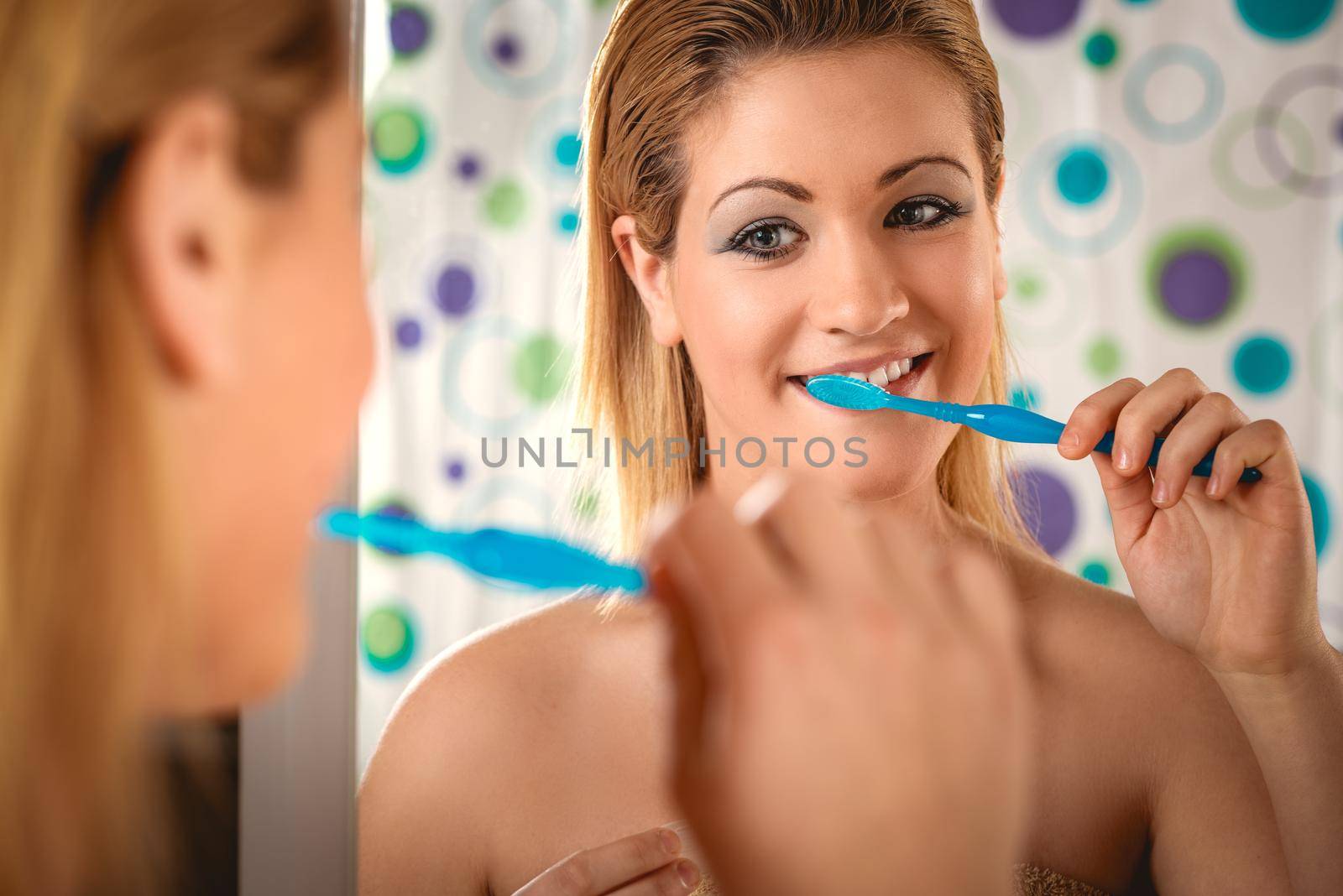 Young beautiful woman brushing her healthy teeth. 