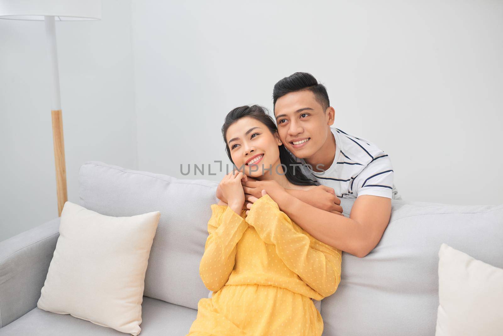 Young couple on the sofa enjoying a movie together