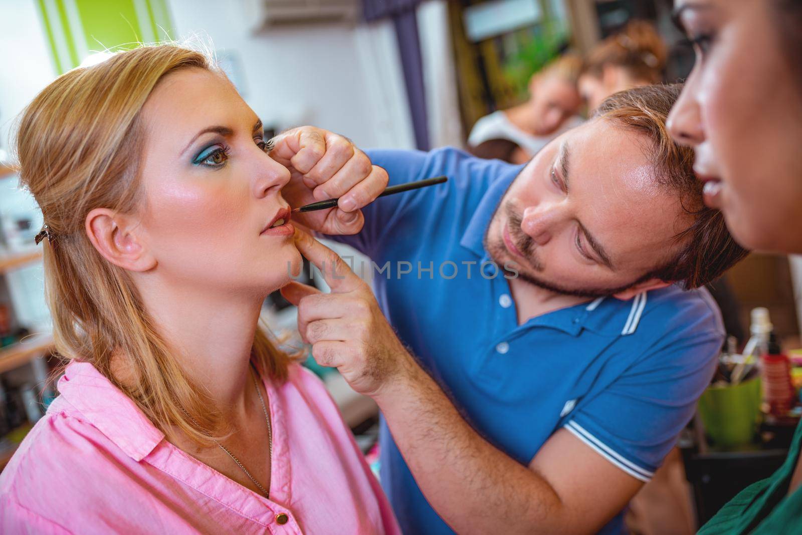 Makeup teacher is helping students training to become makeup artist.