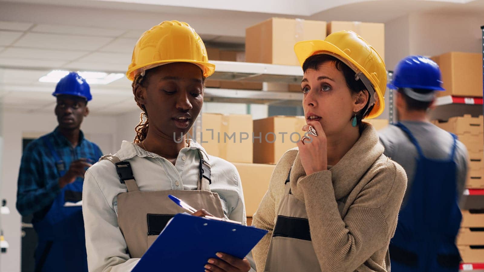 Diverse team of women counting number of merchandise in warehouse space, looking at products on racks and shelves. Young colleagues planning order distribution, checking cargo goods.