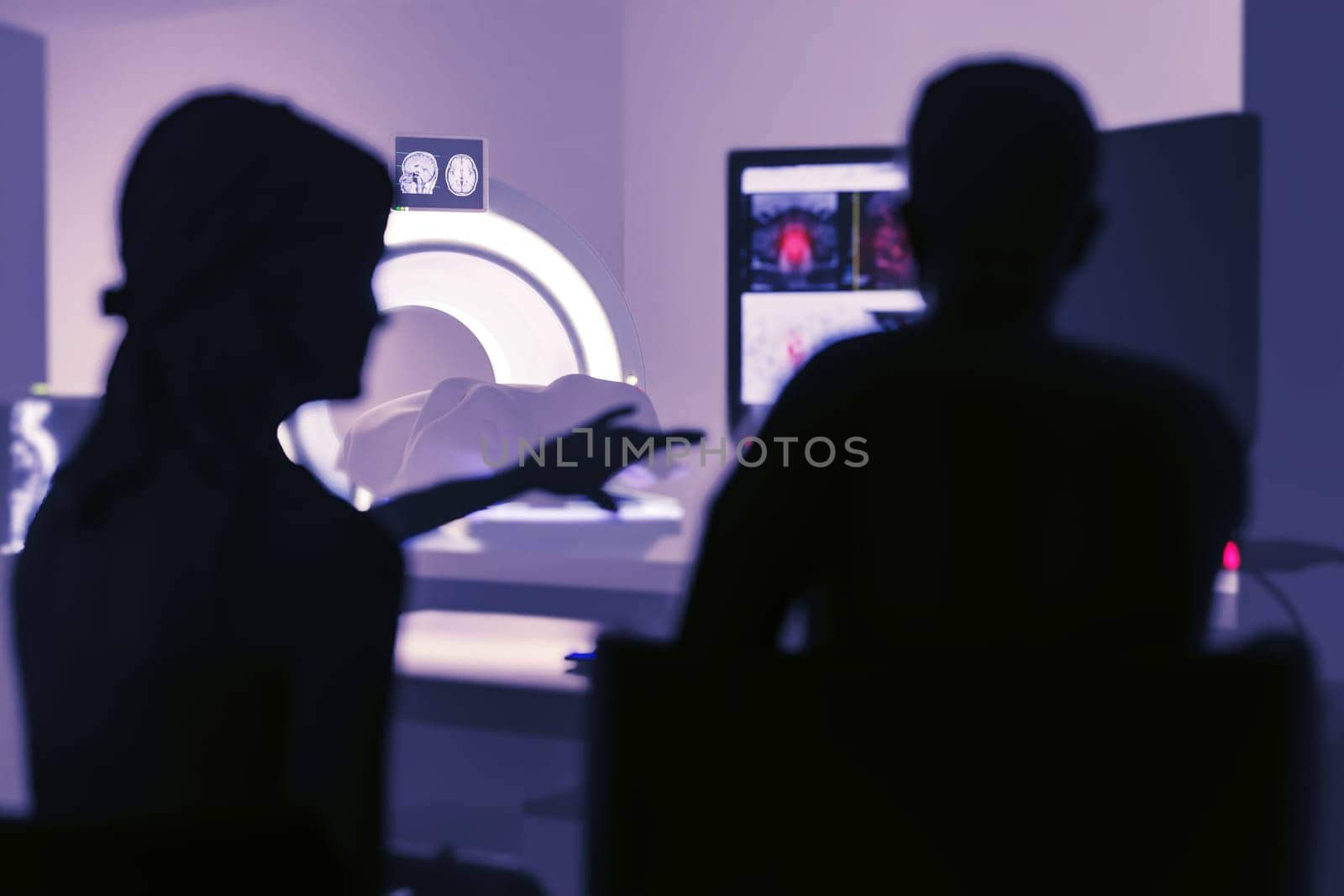 In Control Room Doctor and Radiologist Discuss Diagnosis while Watching Procedure and Monitors Showing Brain Scans Results, In the Background Patient Undergoes MRI or CT Scan Procedure.3D rendering . by samunella