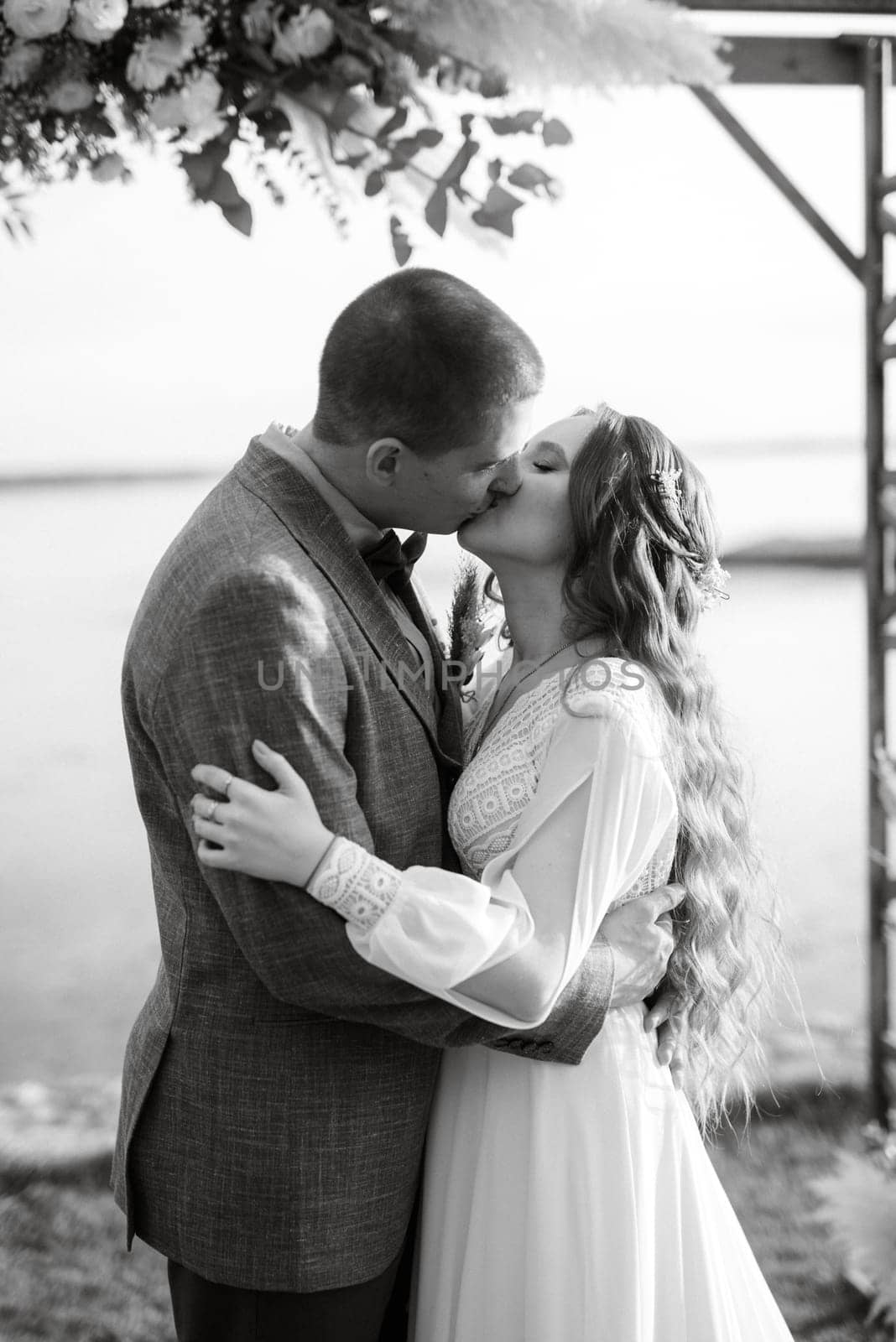 wedding ceremony of the newlyweds in a country cottage on a green hill