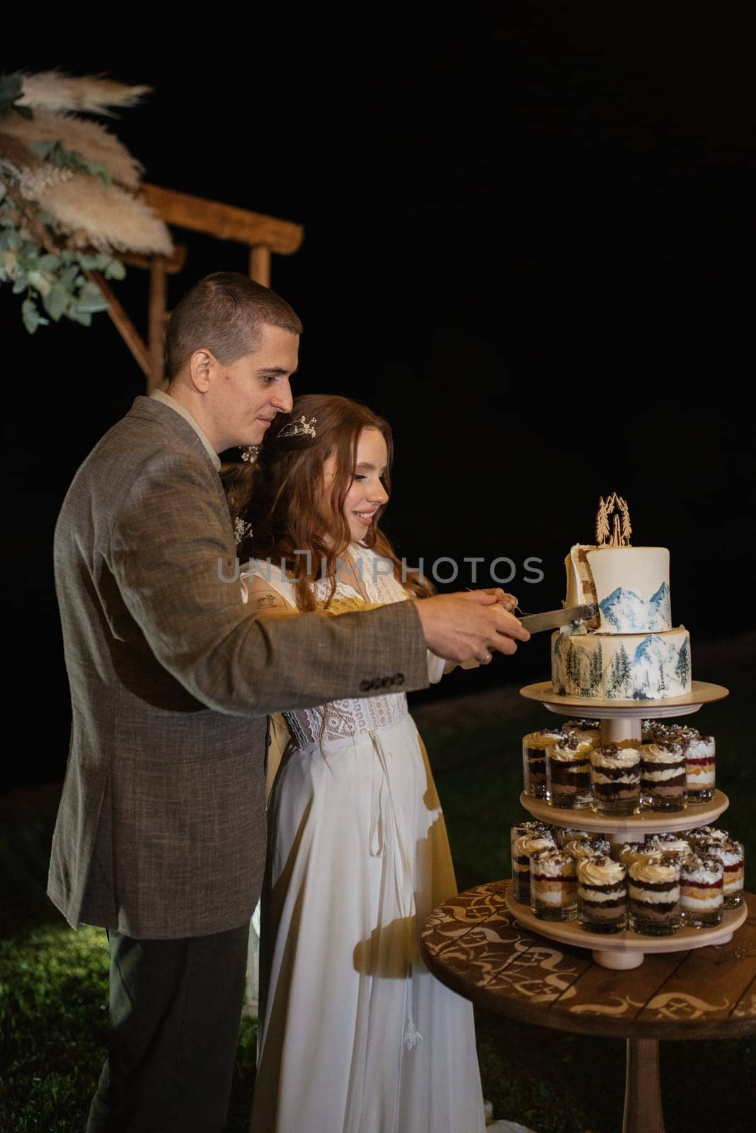 newlyweds happily cut, laugh and taste the wedding cake