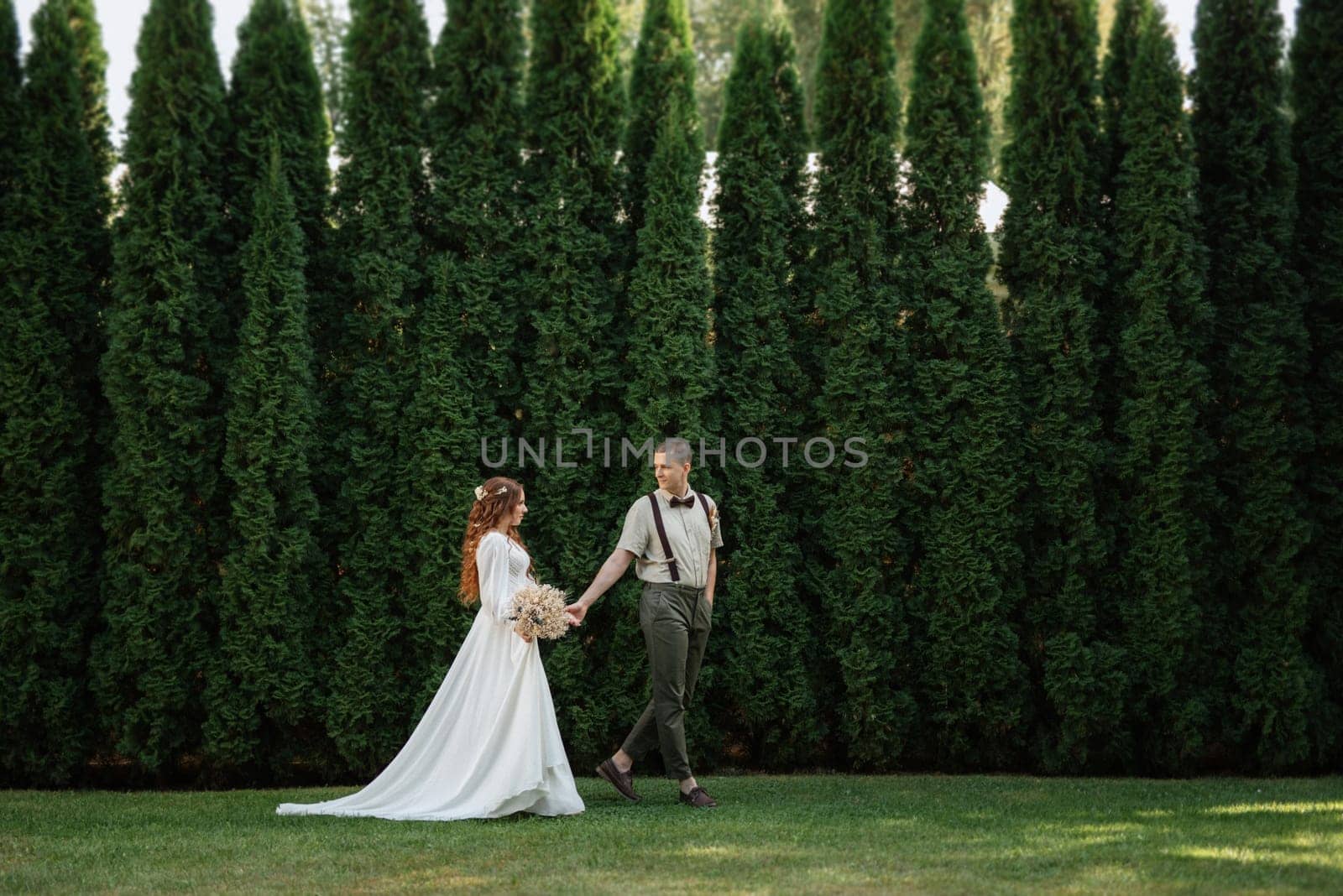 wedding walk of the bride and groom in a coniferous by Andreua