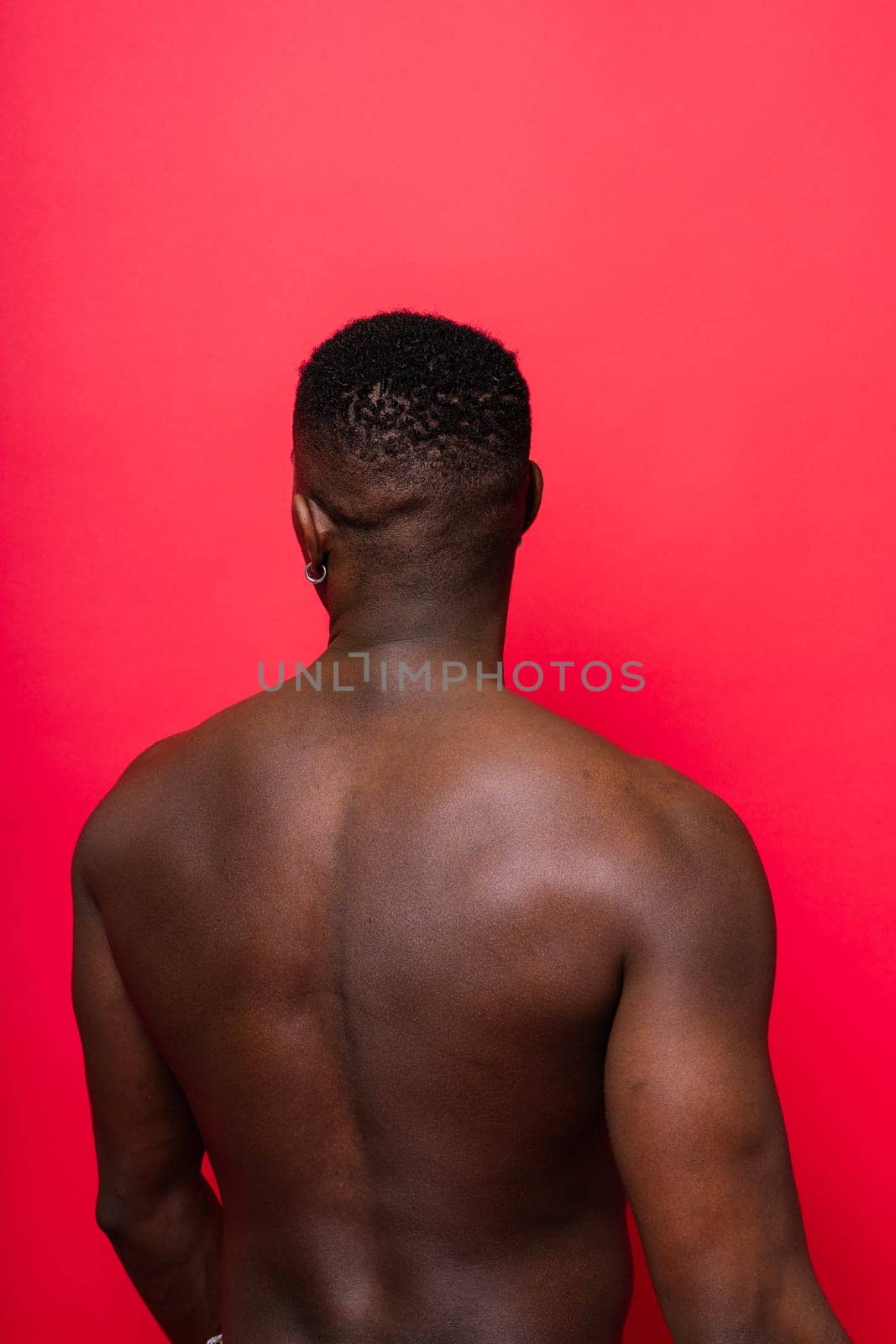 Laughing single handsome young African man over red yellow background with copy space by Zelenin