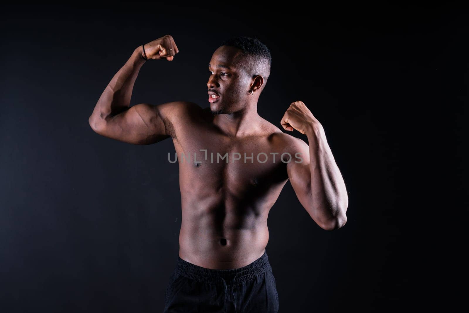 Laughing single handsome young African man over a red yellow background with copy space